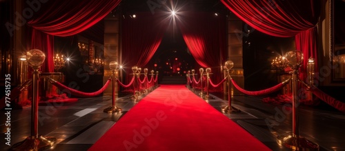 A luxurious red carpet arrangement featuring shiny gold poles and stylish red curtains for a grand event