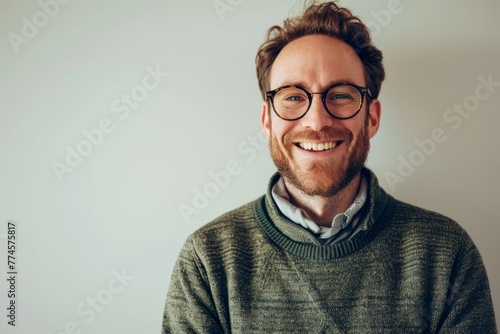 Portrait of a handsome young man wearing glasses and a green sweater