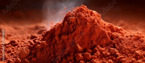 Rising steam can be seen coming out of a close-up view of a heap of red clay
