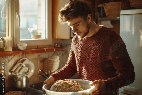 Man in a cozy kitchen enjoying the warmth of fresh bread