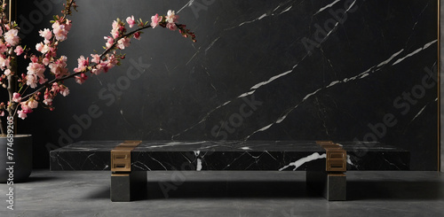 a black marbled table with a black marble top and a white vase with flowers on it.