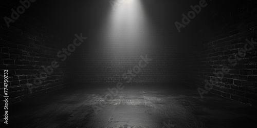 A dark room with a single light shining on the wall. The room is empty and has a feeling of emptiness and loneliness