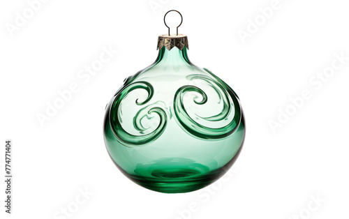 A green glass ornament adorned with delicate swirling patterns