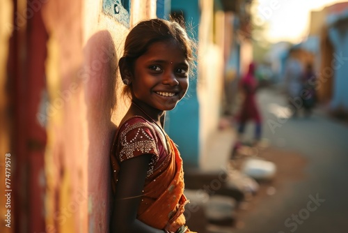Portrait of a beautiful smiling Indian girl on the street at sunset.