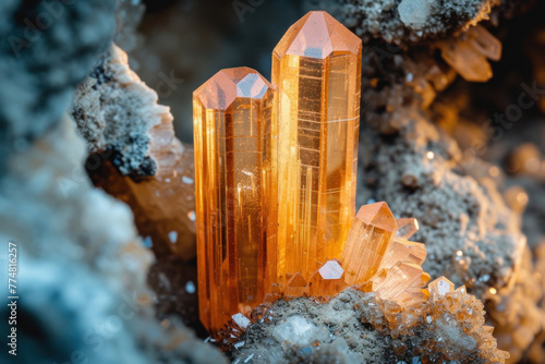 Peach colored uncut imperial topaz crystal deposit on a rock.