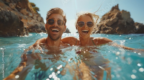 A young couple and a beautiful young woman wearing swimsuits play in the sea or a natural swimming pool showing couples having fun on vacation.