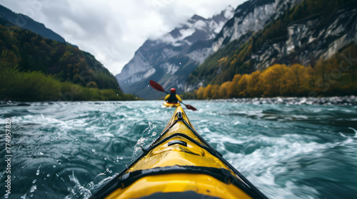 rear view of a man floating in a kayak on a fast, stormy mountain river