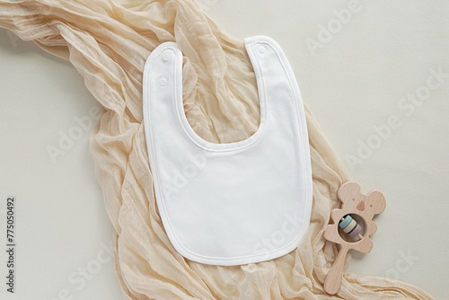White blank baby bib mockup for design presentation, bohemian style flat lay, pregnancy announcement.