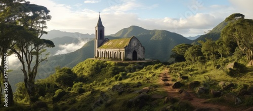 Dominating the landscape, a magnificent church sits atop a hill with its iconic steeple rising against the sky