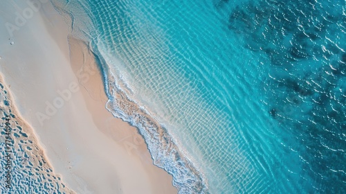 Sand beach from above with light blue transparent water
