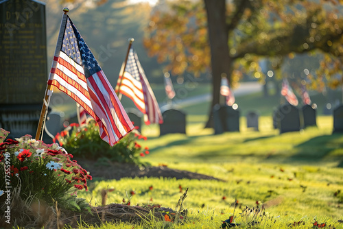 A cemetery with four American flags in the grass. The flags are in different positions, some are standing upright and others are laying down. Concept of patriotism and respect for the deceased
