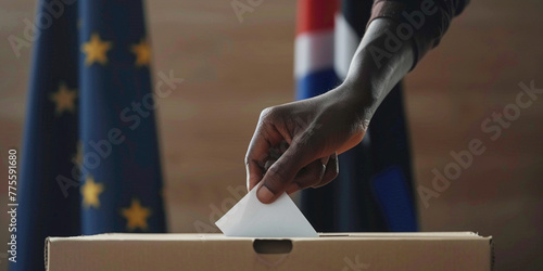 African American unrecognizable man putting their vote in the ballot box with European Union flag on background. President governmental election giving your voice voting concept