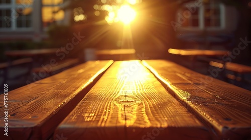 Sunset beams over a wet wooden picnic table after rain