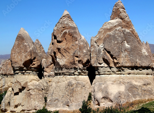 Mushroom-shaped rocks (also called the Fairy Chimneys) close-up in the Rose Valley between the towns of Goreme and Cavusin in Cappadocia, Turkey