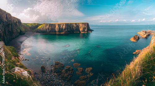 Panoramic view of serene coastal cliffs and ocean at sunrise with gentle tides and clear skies