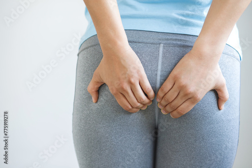 concept of health problems woman has hemorrhoids