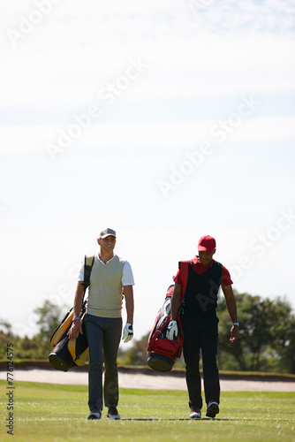 Smile, friends and men walking on golf course with golfing bag for training, health and teamwork. Male people, sports equipment and exercise for activity with sportswear, lawn and trees outdoor