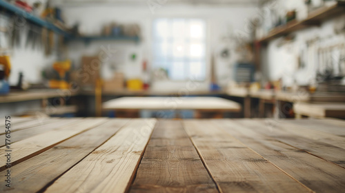 Rustic wooden table in a carpentry workshop with a blurred background of tools and equipment