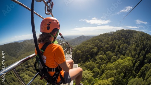 Safety harness clipping onto steel cable ensuring secure and thrilling zip line