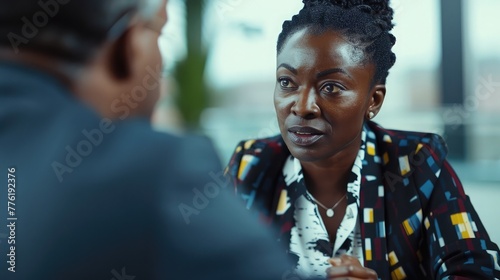A confident black businesswoman negotiating terms with a client, demonstrating assertiveness and strategic thinking in closing deals.