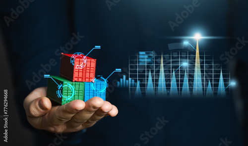 A businessman holds a shipping container transporting goods against the background of charts. Economic growth, production and development. Import and export. Profit from sale of goods