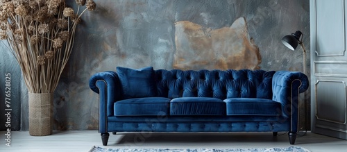 A close up of a blue velvet couch in a room