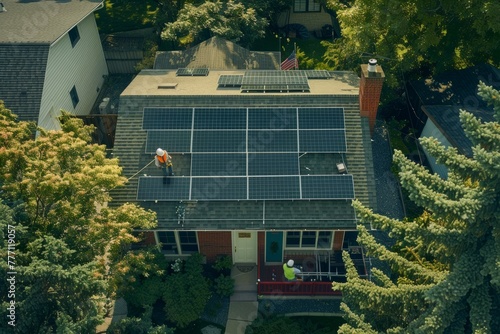 An aerial perspective of a house featuring a solar panel being installed on the roof