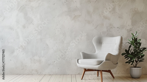 Gray light upholstered armchair on a light background. An example for a minimalist design presentation