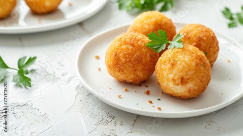 Arancini balls on the white plate on light table. Snack, Sicilian street food menu starter. Copy space for recipe