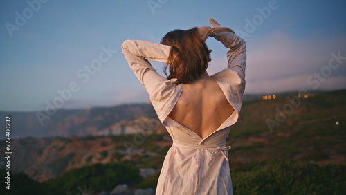 Romantic lady dancing sunset nature making relaxed movements on ocean cliff