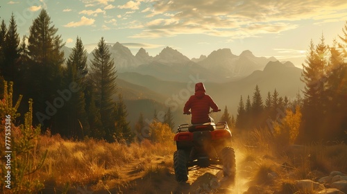 Person on ATV enjoying sunset in forested mountain landscape