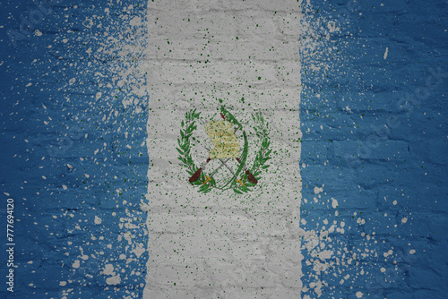 painted big national flag of guatemala on a massive old brick wall