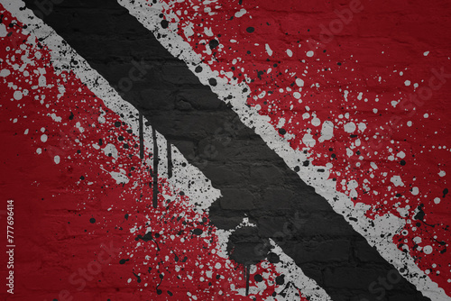 painted big national flag of trinidad and tobago on a massive old brick wall