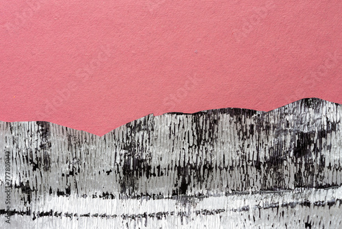 grungy crepe paper with metallic silver finish stained with black ink on rough pink toned scrapbooking paper