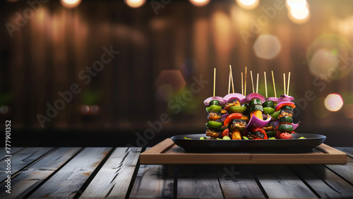 Grilled vegetable skewers on a plate with blurred lights background