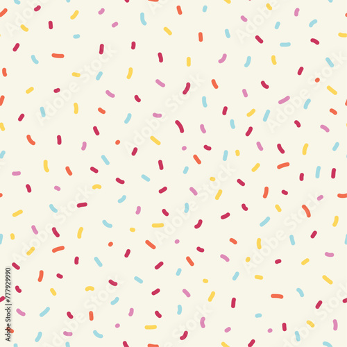 Seamless sprinkle pattern. Colorful background design with cute pastel colored sprinkles. 