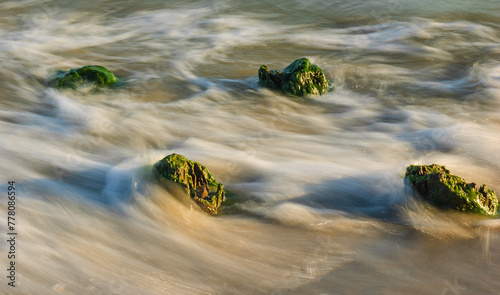 Seascape. Breakwater in the sun. Leba. Baltic Sea. Poland.