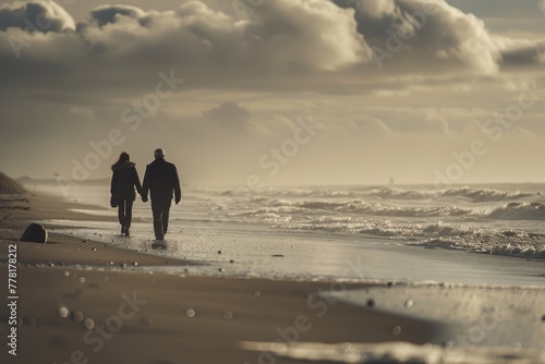 Couple walks on beach listening to music, enjoying sound of waves - canon eos 5d mark iv photo