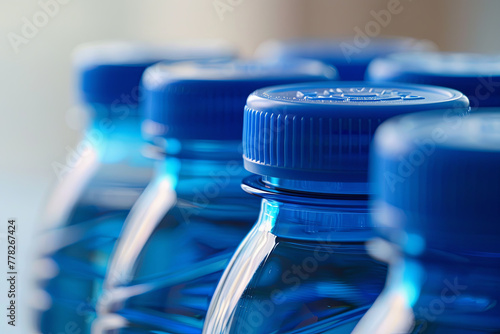 Four blue plastic water bottles lined up