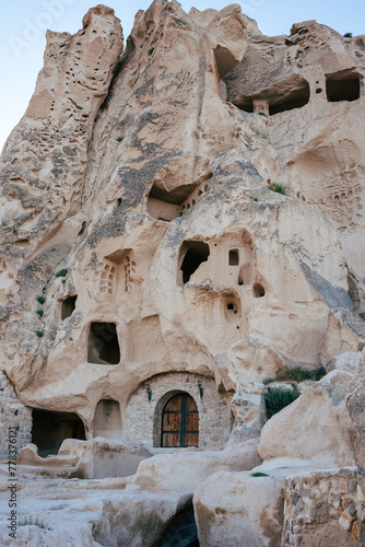 Time-worn cave houses carved into the rock face of Cappadocia, standing as a testament to ancient ingenuity