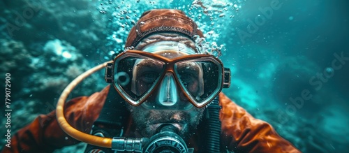 a diver in a wetsuit underwater wearing a mask and goggles for underwater research.