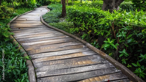 Wooden pathway meandering through a peaceful garden with a wooden platform background