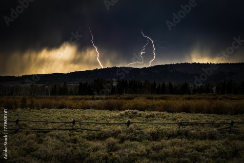 Mesmerizing lightning storm over the green field in Jackson Hole