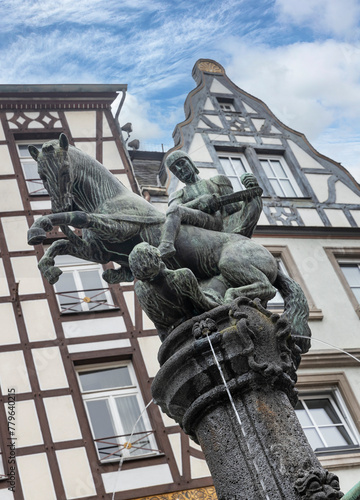 Historic fountain. Statue of the holy Martin, Cochem, Holy Saint-Martin-Statue Moselle. Half timered houses. Cochem Rhineland-Palatinate Germany. River Moselle.