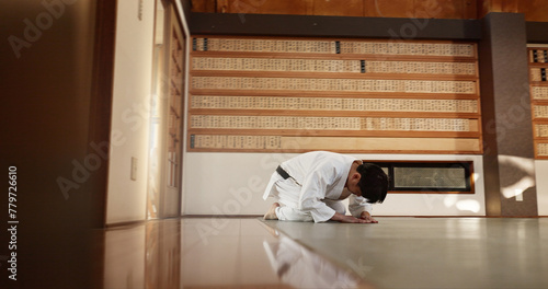 Japanese student, bow or man in dojo to start aikido practice, discipline or self defense education. Black belt master greeting, athlete learning respect or ready in fighting class or training alone