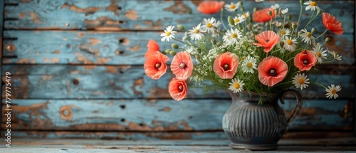 Clay jug with daisy and poppies on provencal wood plank background.
