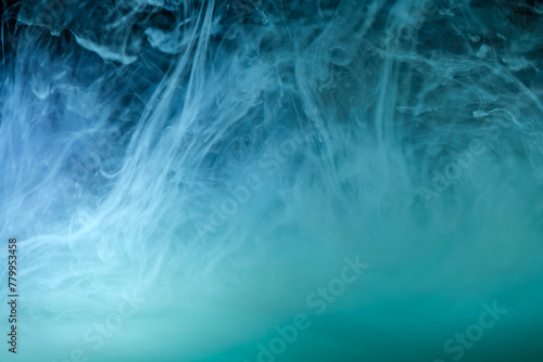 clouds of blue smoke on a black background, clouds of paint in water, aquarium, abstract background, texture