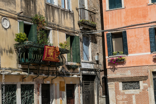 Venetian architectural landmarks and old houses facades. Urban tourism in summer. Residential area in city of Venice, Veneto, Italy, Europe.