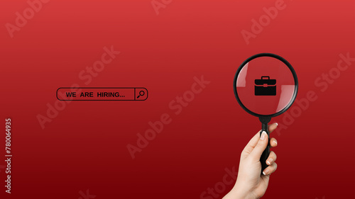 We're hiring a red vector banner. Employee vacancy announcement with a Magnifying Glass on a red background.