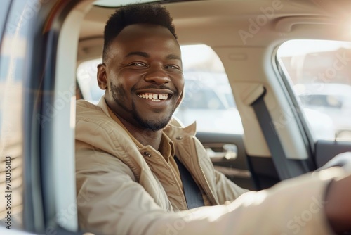 Handsome young man is driving a car and smiling driving a car with a clear view of the city through the window. showcasing safe driving with a seatbelt